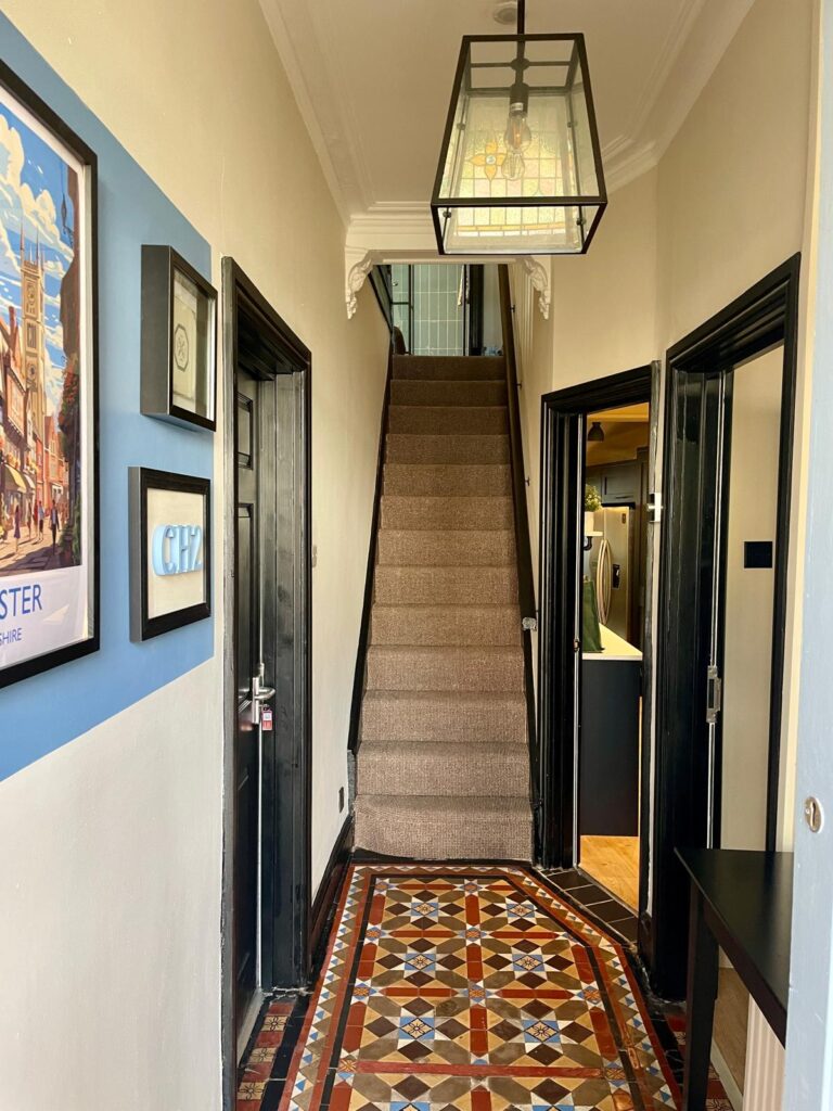 Minton tiles have been restored giving a warm inviting hall